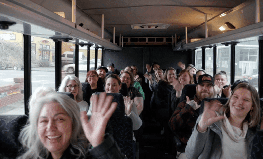 A group of people having fun on a charter bus.