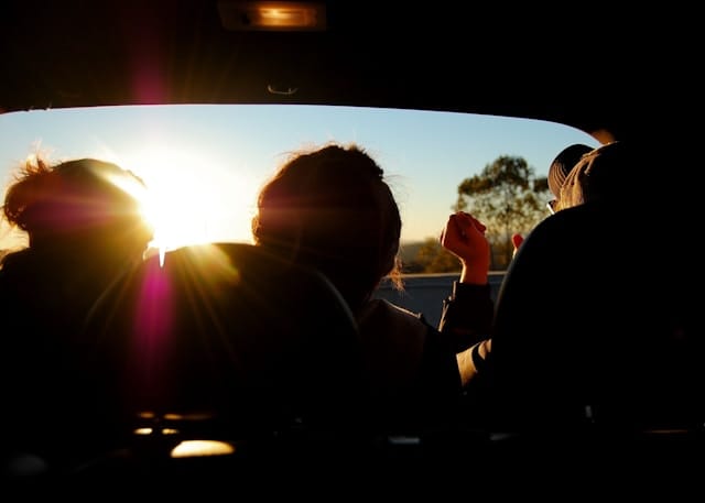 Three people sitting in a car