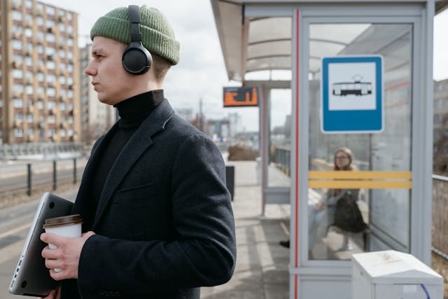 A man waiting at a bus stop